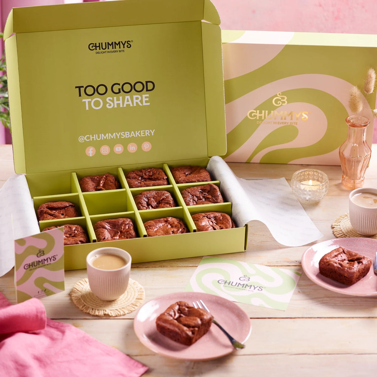 An open Chummys box of brownies, one square on a plate
