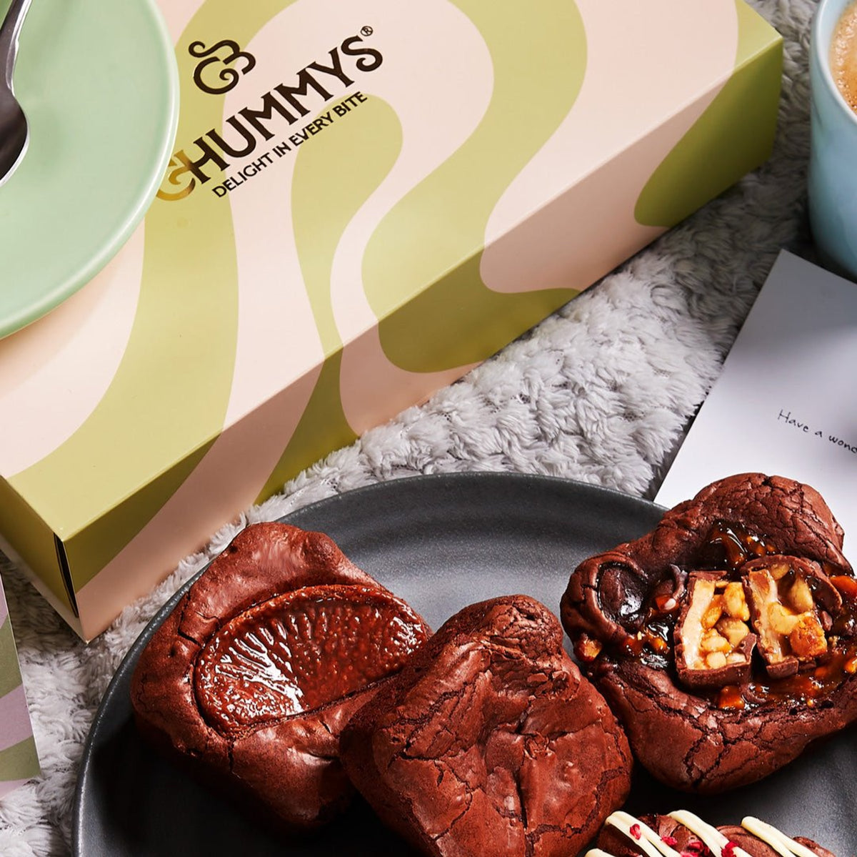 Three Chummys bronuts beside the box and the printed card